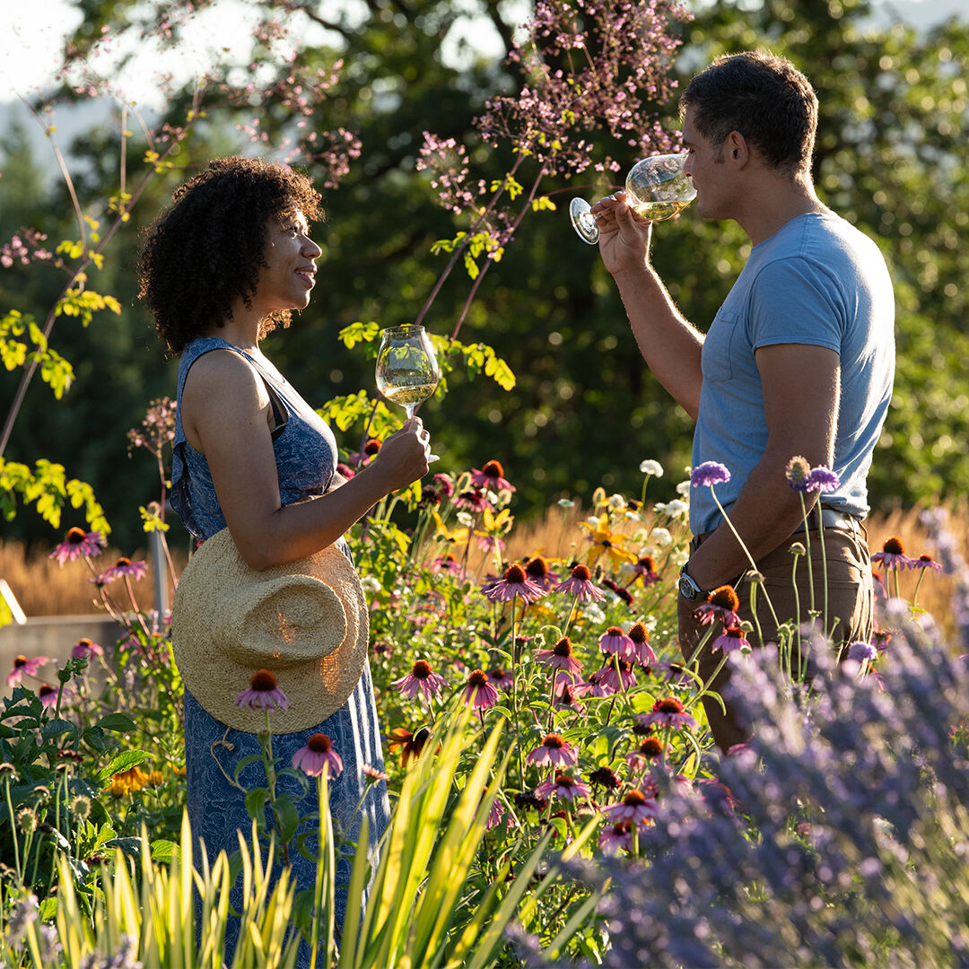 Couple tasting wine in Penner-Ash garden.